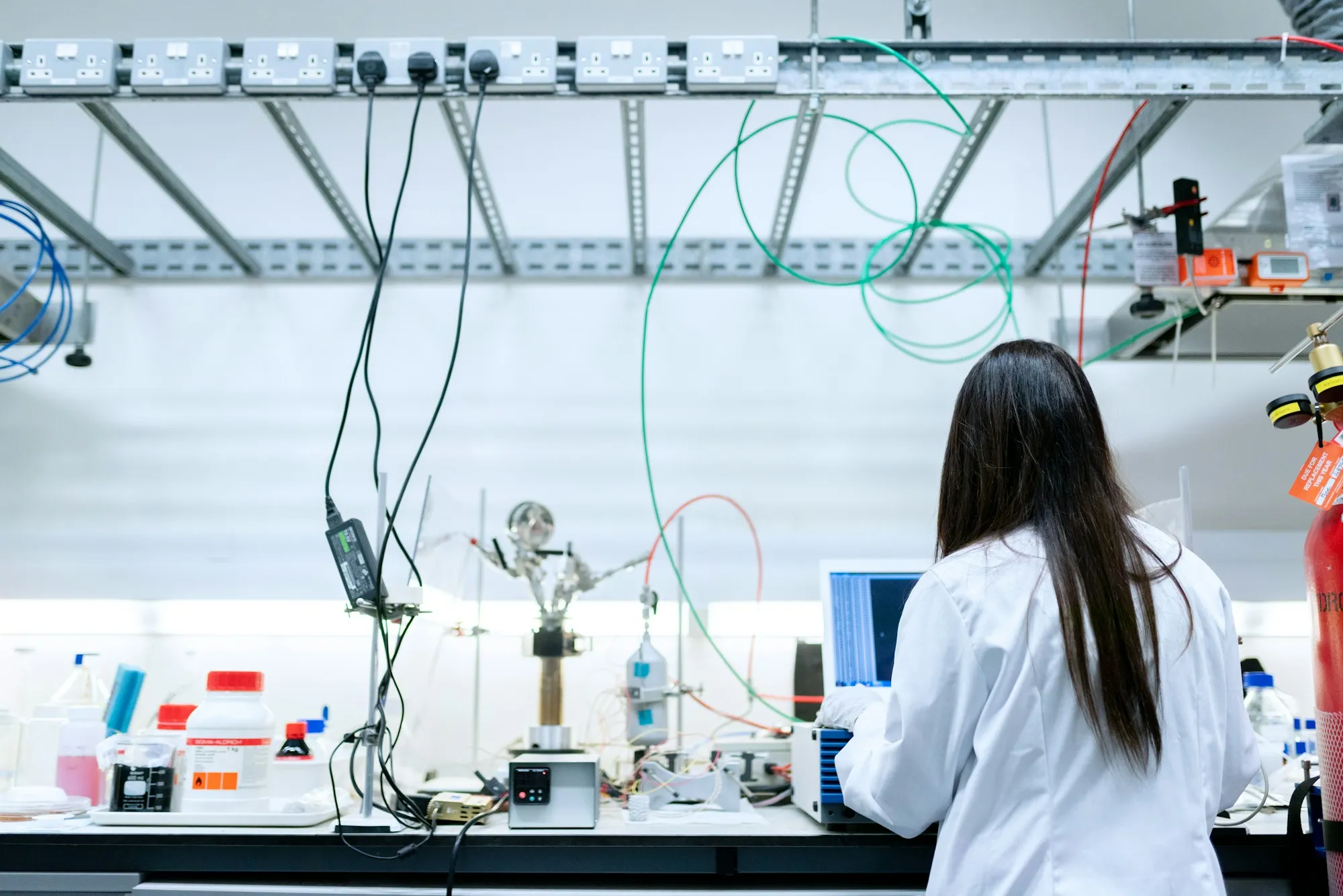 A chemical engineer working at a laboratory test bench