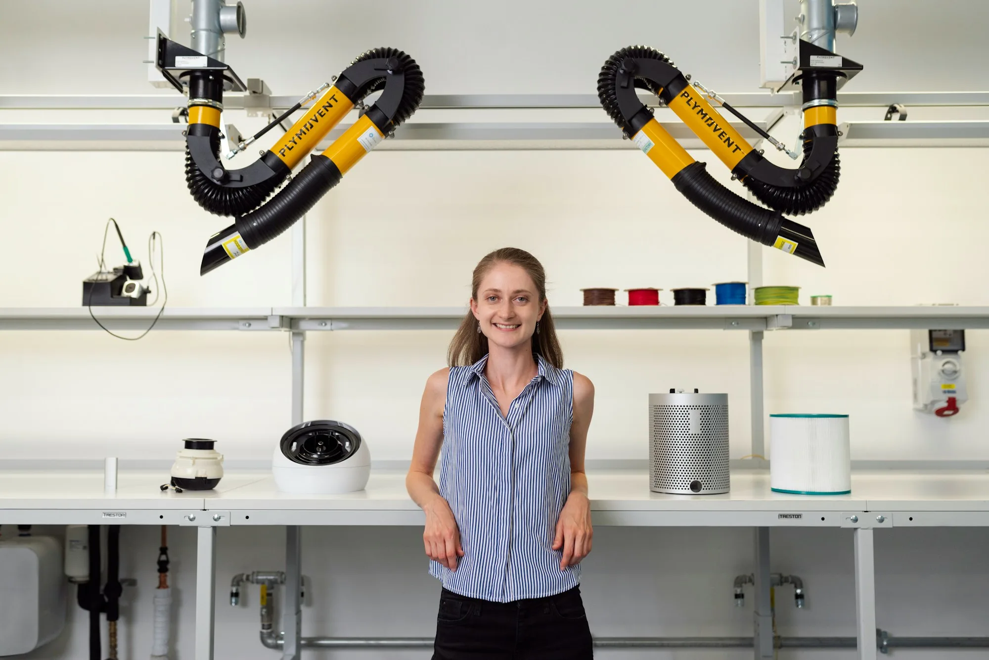 An engineer standing beside workshop test equipment