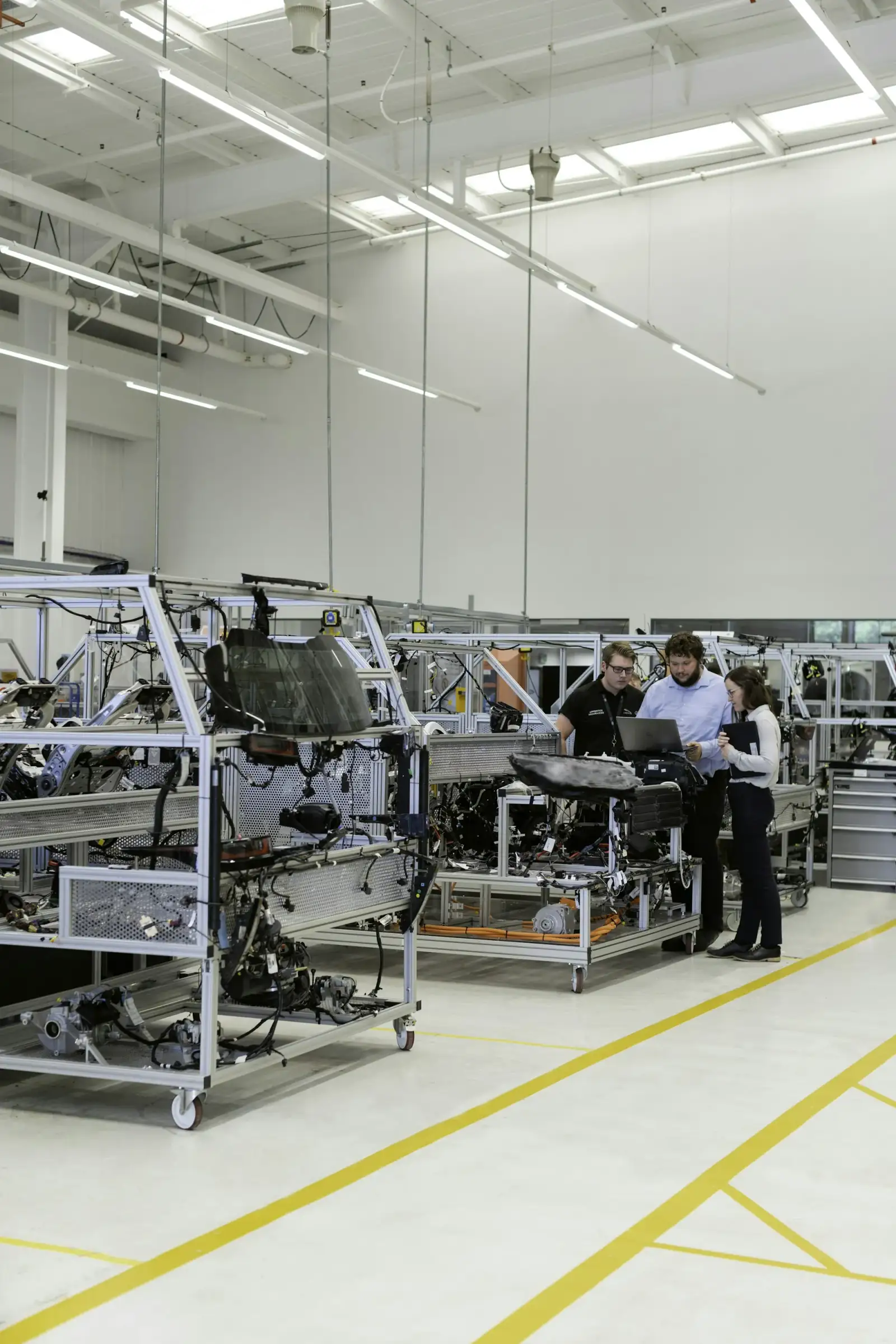 Engineers working together on an automotive production floor