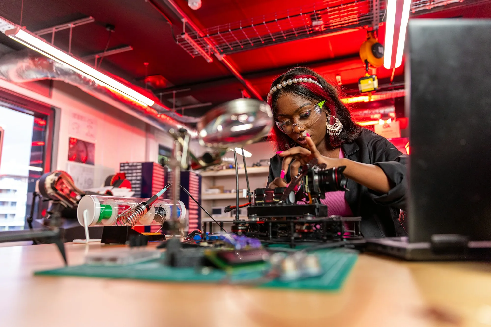 An engineer inspecting an electronic component in a laboratory